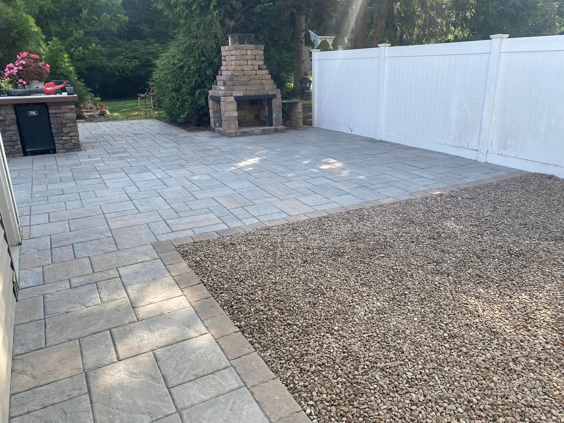 Custom patio with outdoor fireplace and bluestone pavers