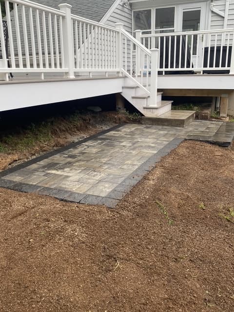 Paver walkway under deck with steps